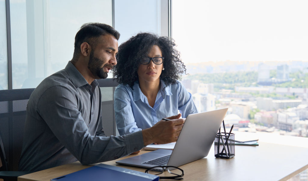 Colleagues reviewing information during a business meeting